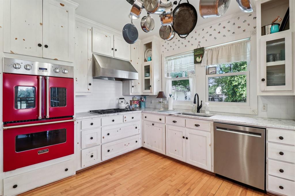 1590 Airport Road Aledo, TX 76008 - Photo 10 of 26 a kitchen with stainless steel appliances a stove a microwave and cabinets