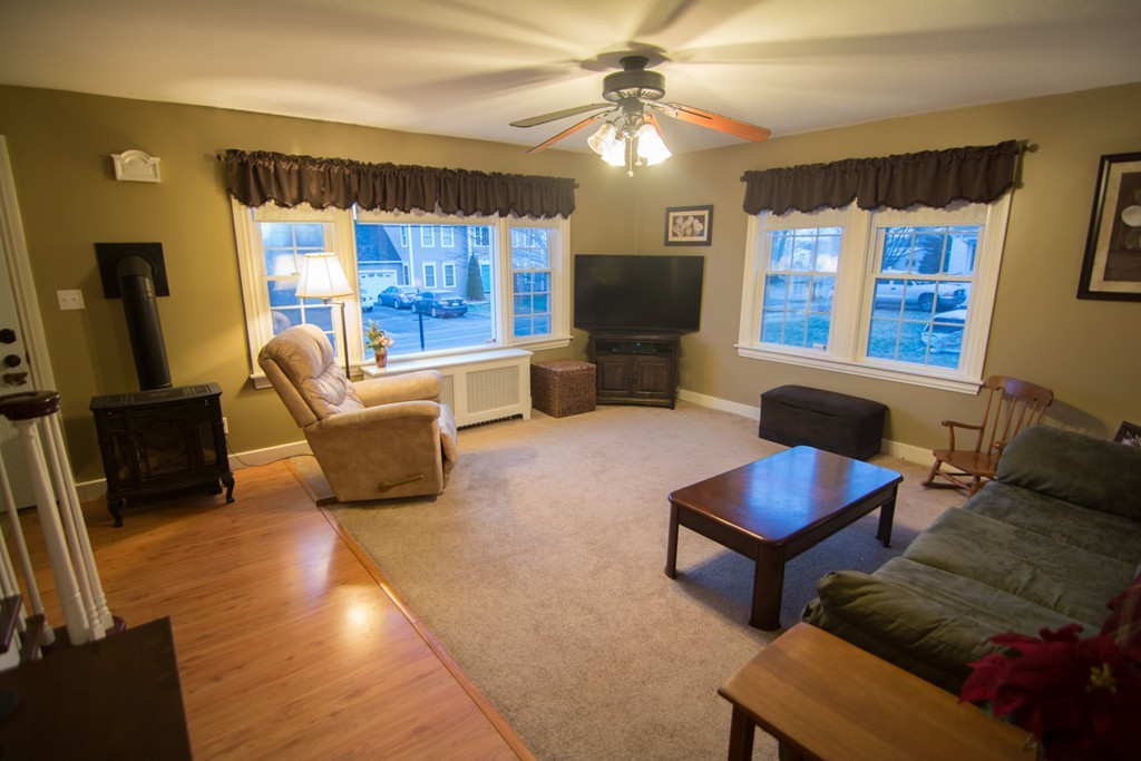 5 Farquhar Road Sturbridge, MA 01566 - Photo 2 of 27 a living room with furniture a flat screen tv and floor to ceiling window