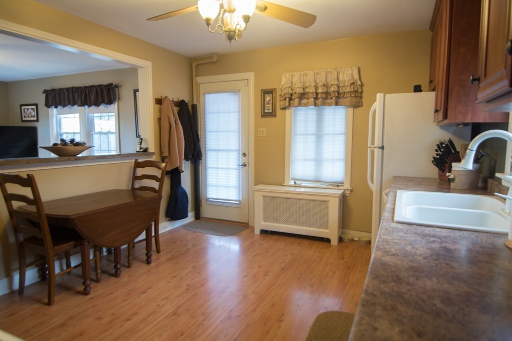 5 Farquhar Road Sturbridge, MA 01566 - Photo 8 of 27 a kitchen with stainless steel appliances wooden floor and dining table