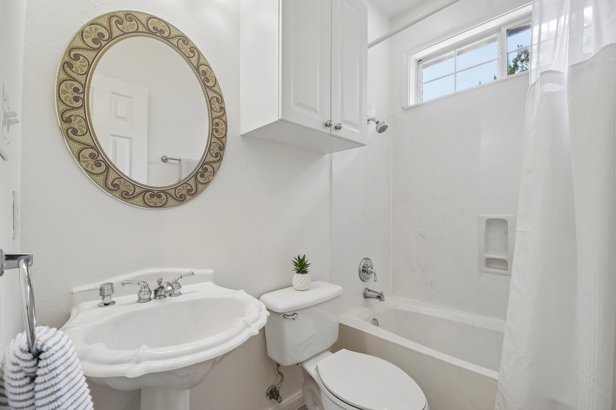 20609 Bridle Path Road Lago Vista, TX 78645 - Photo 18 of 30 A pristine bathroom featuring a classic pedestal sink and tub with shower.