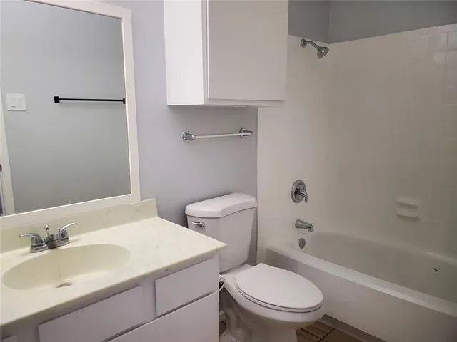 a bathroom with a bathtub and toilet