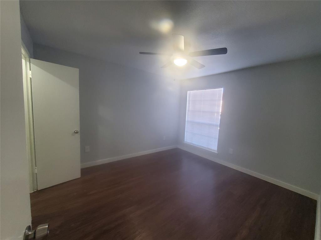 12482 Abrams Road, Unit 1402 Dallas, TX 75243 - Photo 19 of 32 an empty room with wooden floor and windows