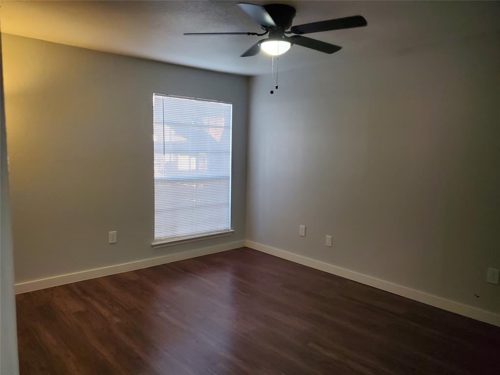 12482 Abrams Road, Unit 1402 Dallas, TX 75243 - Photo 22 of 32 an empty room with wooden floor fan and windows