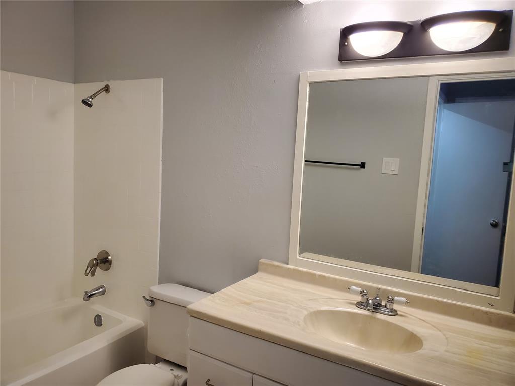12482 Abrams Road, Unit 1402 Dallas, TX 75243 - Photo 27 of 32 a bathroom with a sink a toilet and shower