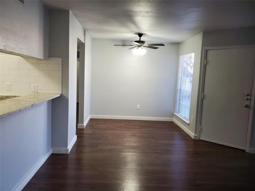 12482 Abrams Road, Unit 1402 Dallas, TX 75243 - Photo 6 of 32 an empty room with wooden floor chandelier fan and windows