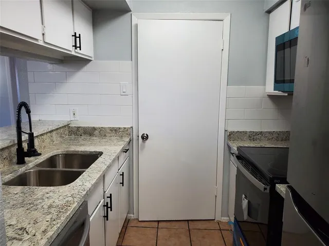 a kitchen with a sink and a refrigerator
