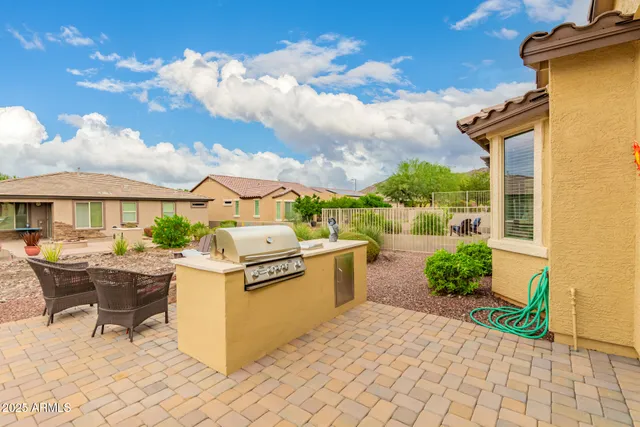 a view of a patio with couches and table and chairs and potted plants