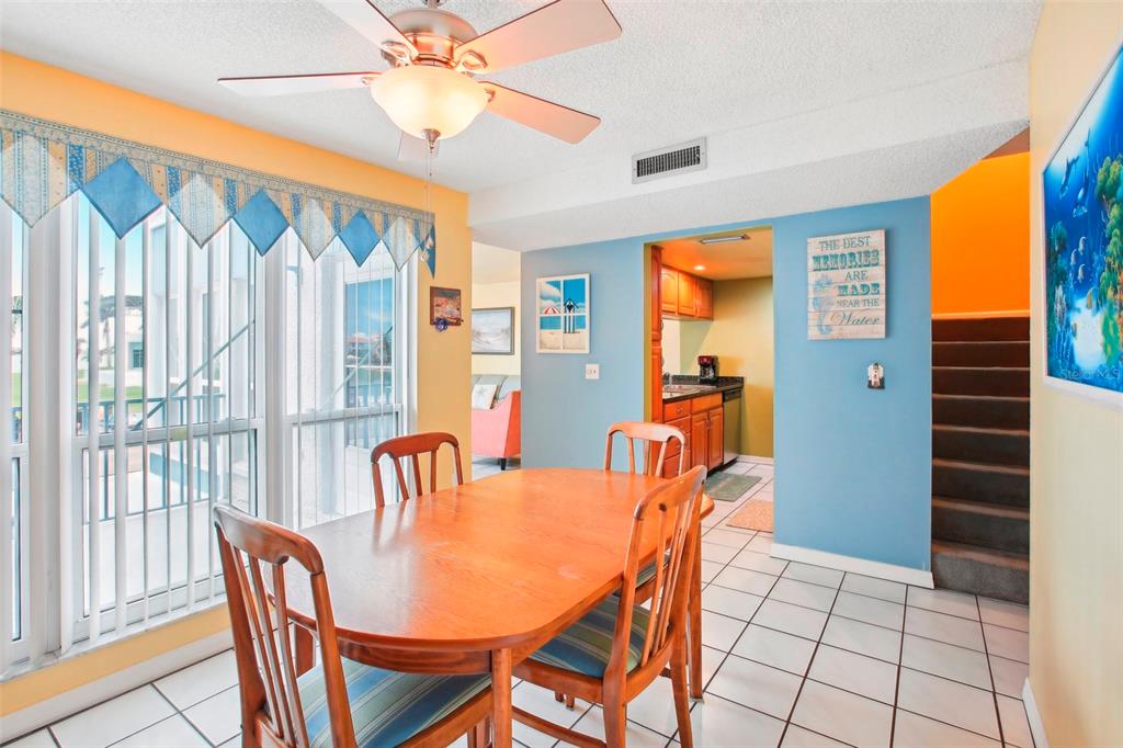 343 Rex Place, Unit F Madeira Beach, FL 33708 - Photo 11 of 28 a dining room with furniture and window