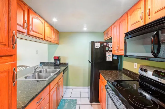 a kitchen that has a sink and a stove