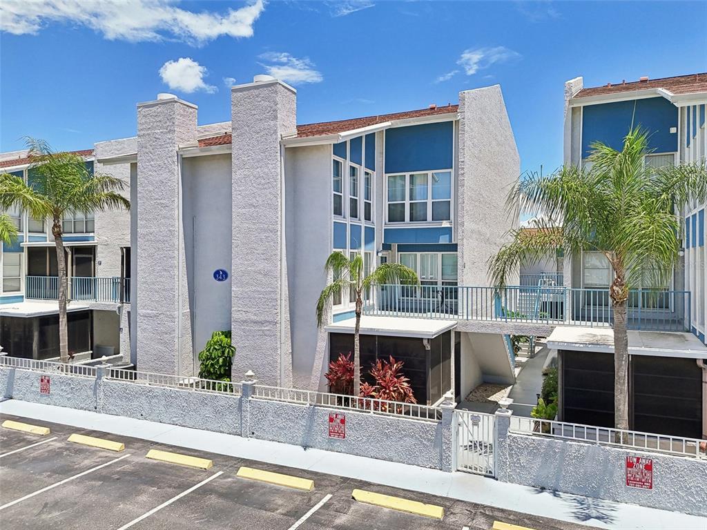 343 Rex Place, Unit F Madeira Beach, FL 33708 - Photo 2 of 28 a view of a building with sitting area