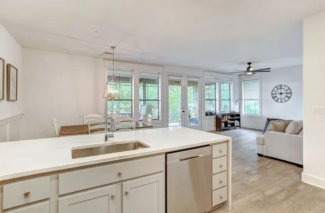 a kitchen with sink attached with living room