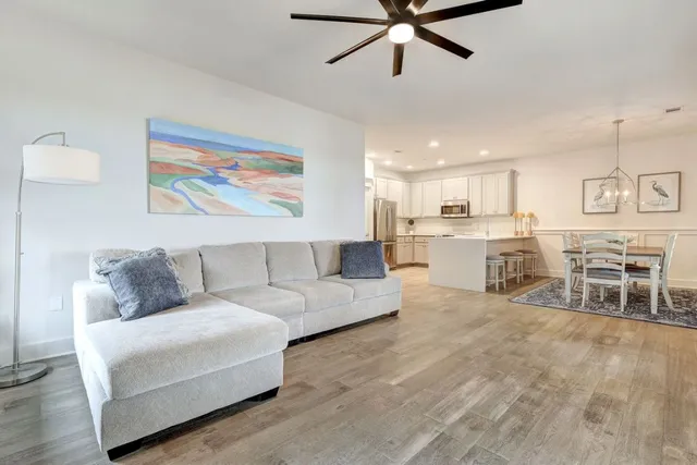 a living room with furniture and kitchen view