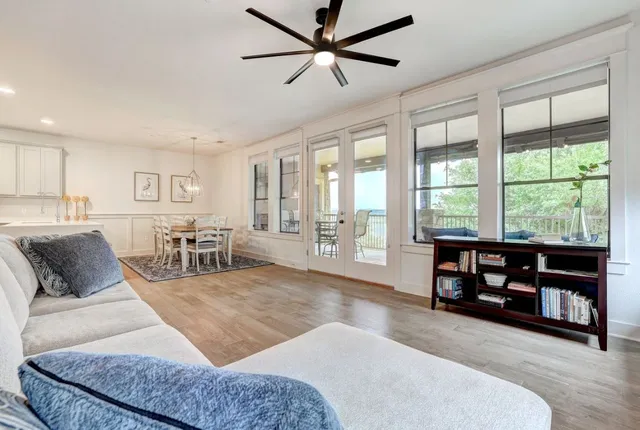 a living room with furniture and large windows