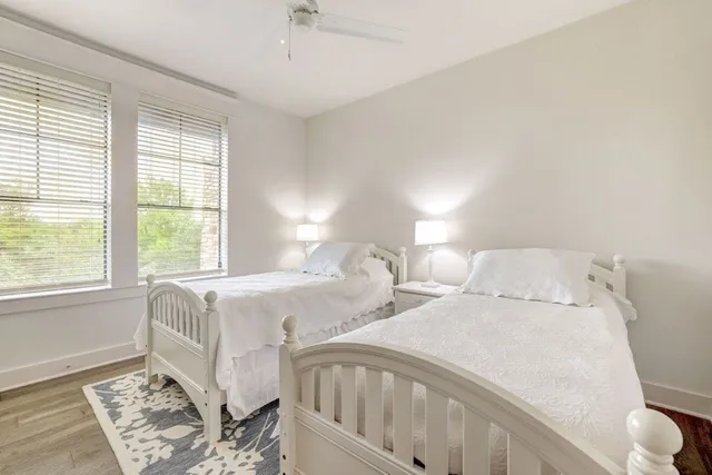 a bedroom with two beds and a window