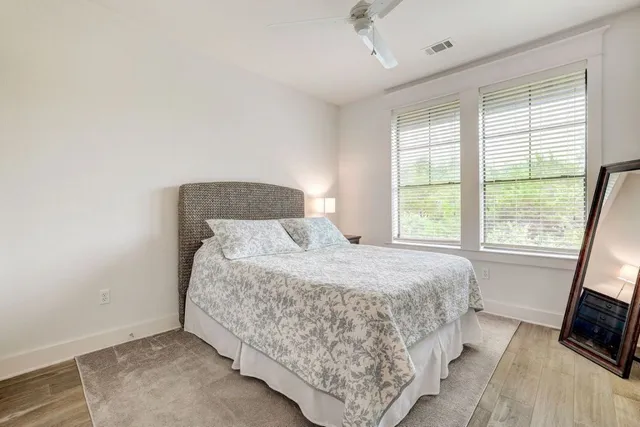 a bedroom with a bed flat screen tv and window