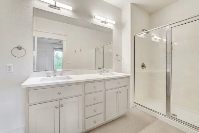 a bathroom with a double vanity sink mirror and next