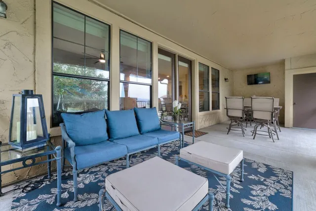 a living room with furniture and a floor to ceiling window