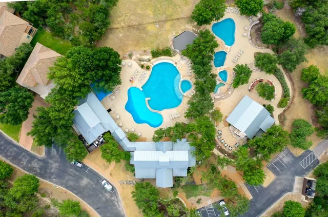 an aerial view of a house with a swimming pool yard and outdoor seating
