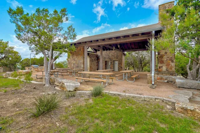 a backyard of a house with table and chairs