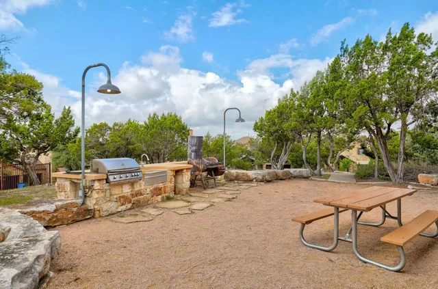 a view of a backyard with a table and chairs