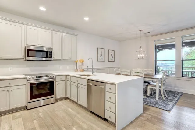 a kitchen with a stove a sink and a microwave