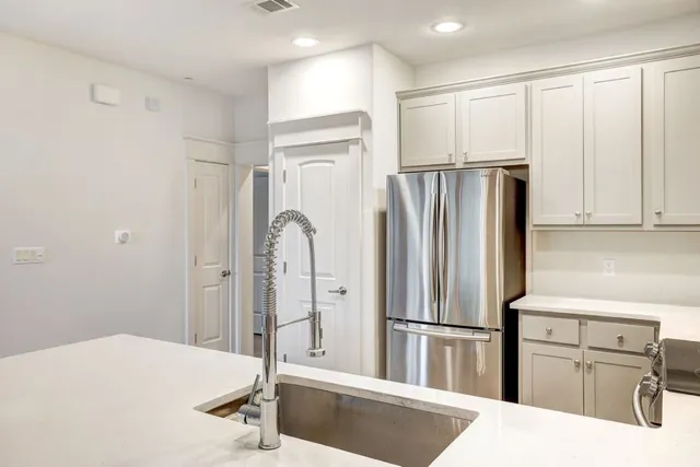 a kitchen with stainless steel appliances a refrigerator and cabinets
