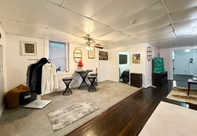 a living room with furniture gym equipment and a table