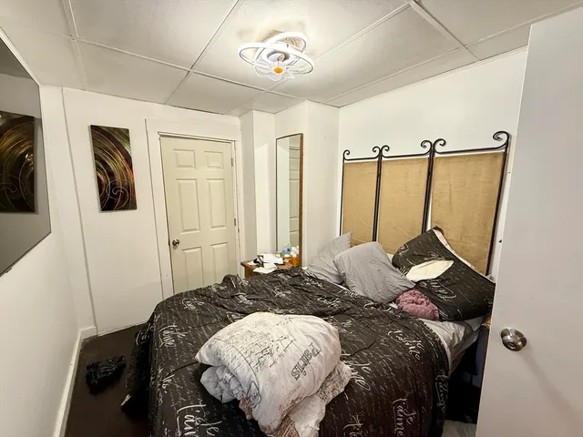 a bed sitting in a bedroom next to a window