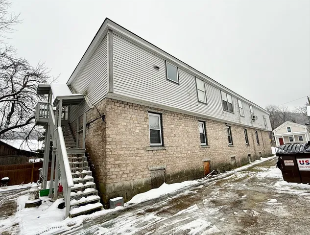 a view of a house with wooden stairs