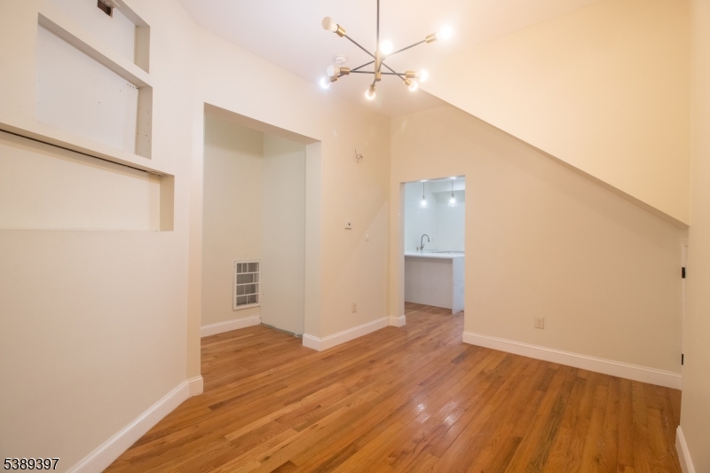 187 Littleton Avenue, Unit 1 Newark, NJ 07103 - Photo 13 of 22 a view of an empty room with wooden floor