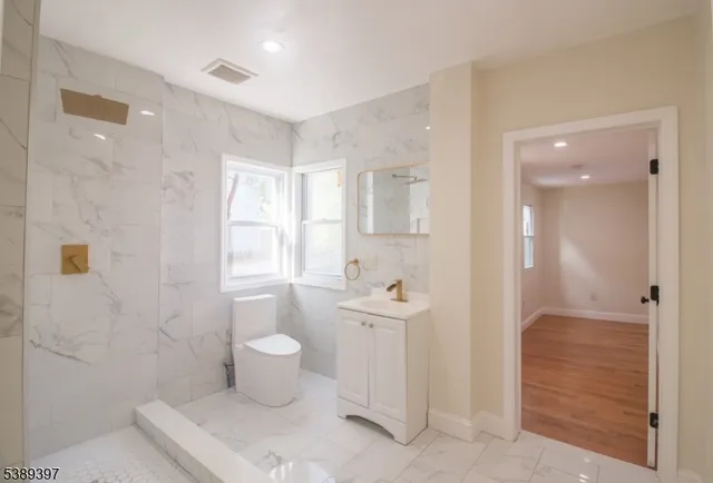 a bathroom with a toilet sink and shower