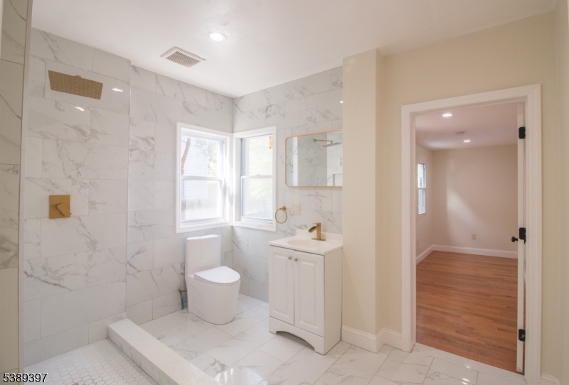 187 Littleton Avenue, Unit 1 Newark, NJ 07103 - Photo 17 of 22 a bathroom with a toilet sink and shower