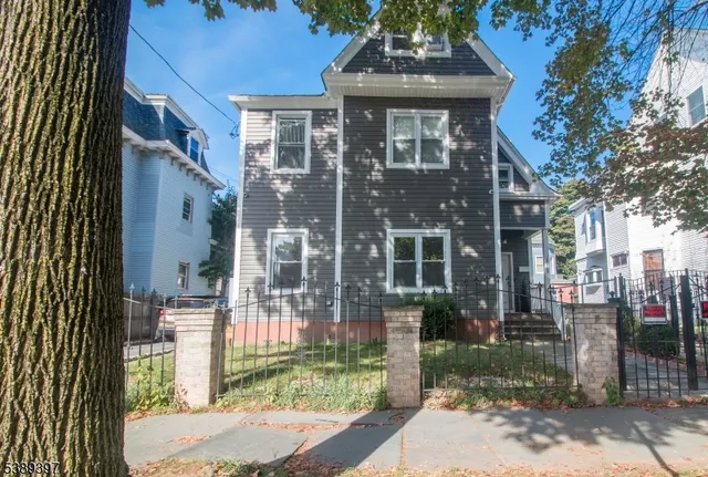 a front view of a building with a garden
