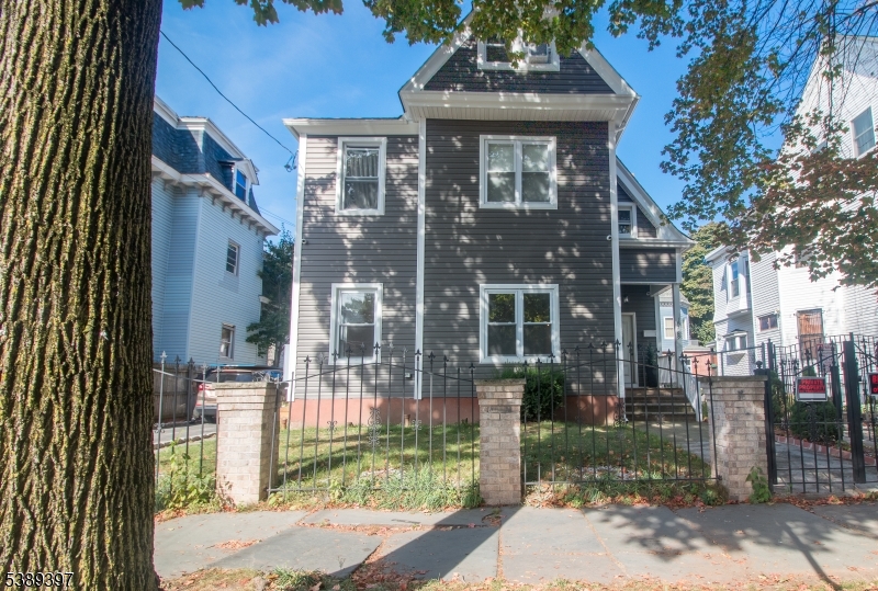 187 Littleton Avenue, Unit 1 Newark, NJ 07103 - Photo 19 of 22 a front view of a building with a garden