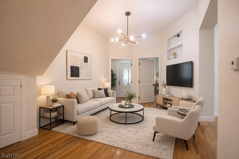 187 Littleton Avenue, Unit 1 Newark, NJ 07103 - Photo 2 of 22 a living room with furniture a flat screen tv and kitchen view