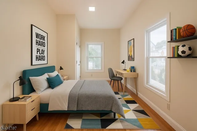 a bedroom with a bed and wooden floor
