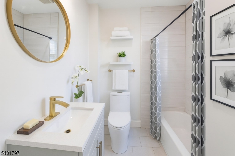187 Littleton Avenue, Unit 1 Newark, NJ 07103 - Photo 6 of 22 a bathroom with a sink a toilet and a mirror