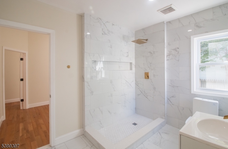 187 Littleton Avenue, Unit 1 Newark, NJ 07103 - Photo 7 of 22 a bathroom with a shower bathtub and sink
