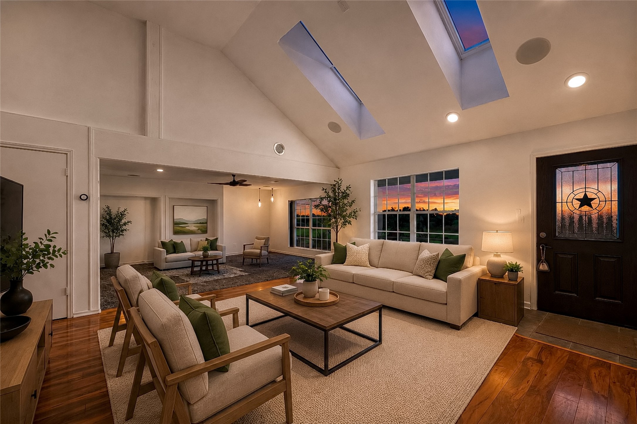 358 Easley Road Smithville, TX 78957 - Photo 5 of 36 Virtually staged - Natural light floods this living area through generous windows and skylights, showcasing polished hardwood floors.