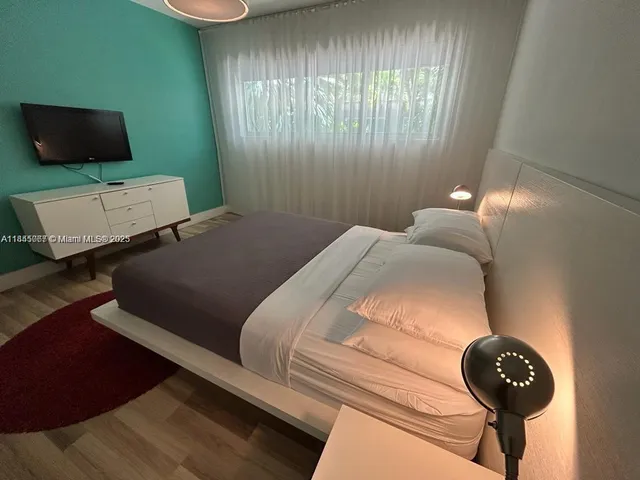 a bedroom with a bed and a chair
