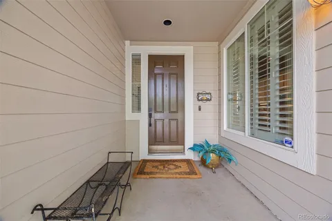a view of front door of house with potted plant