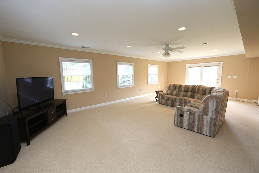 4005 Picardy Drive Raleigh, NC 27612 - Photo 12 of 19 Lower level is huge! Perfect In-law or Teen Suite! This level offers this large family room, a large bedroom, and full bath! There is also a large space for crafting, homework, or studying. Den/Family/Great Room
