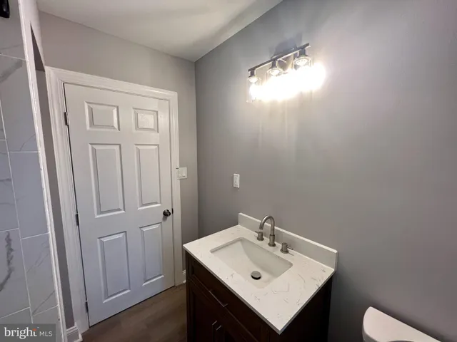 a bathroom with a sink toilet and vanity