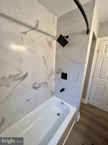 a bathroom with a bathtub and shower