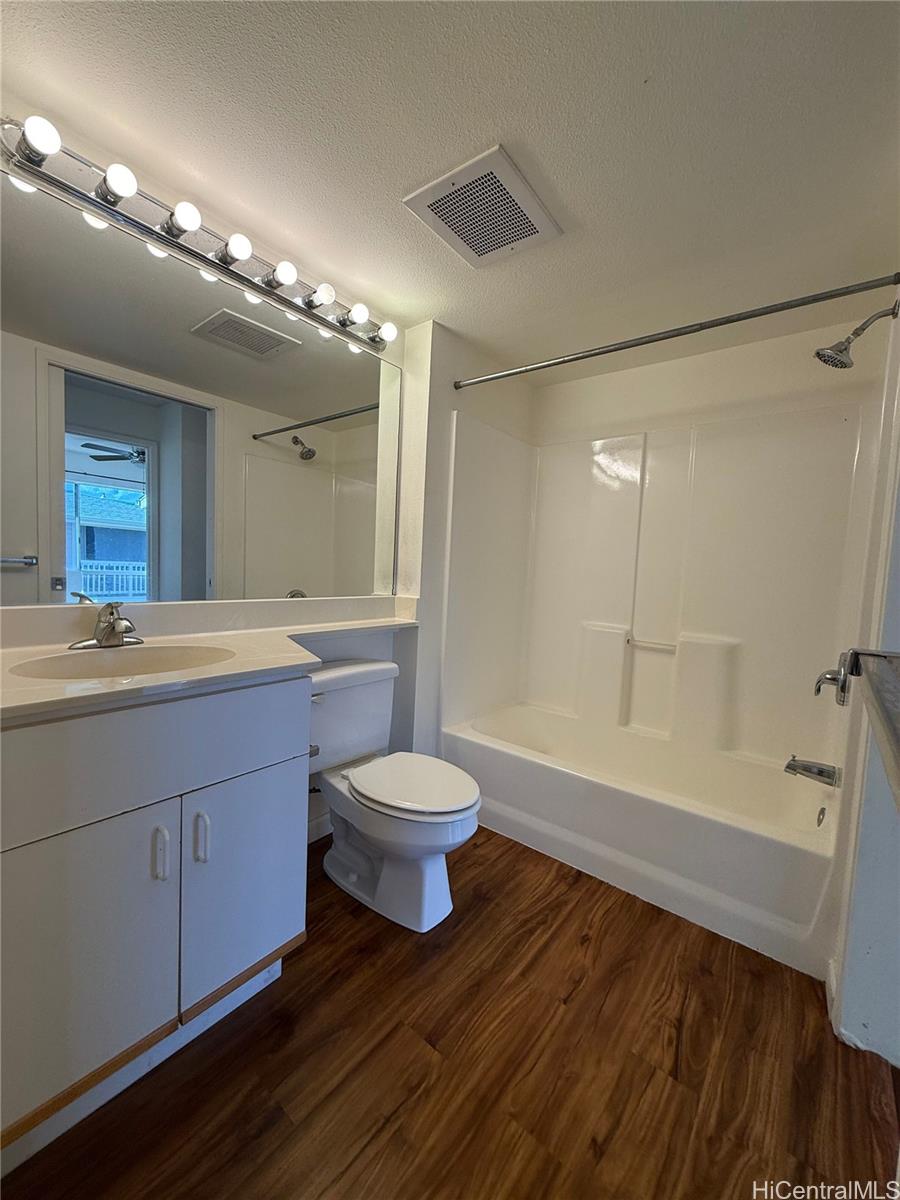 91-1199 Kaneana Street, Unit 2D Ewa Beach, HI 96706 - Photo 8 of 12 a bathroom with a sink a toilet and shower