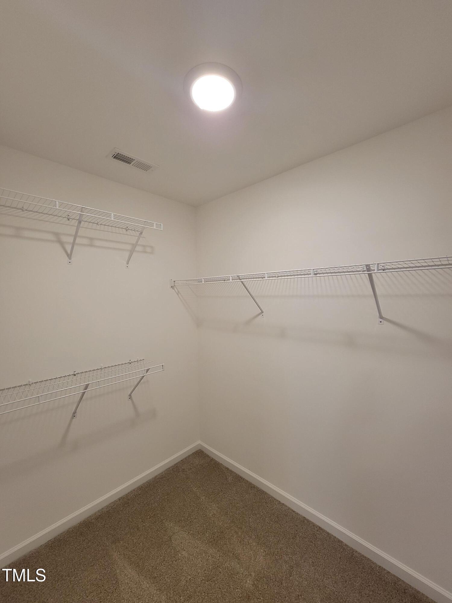 72 Mountain View Drive Garner, NC 27529 - Photo 16 of 22 a view of a room with racks on the wall