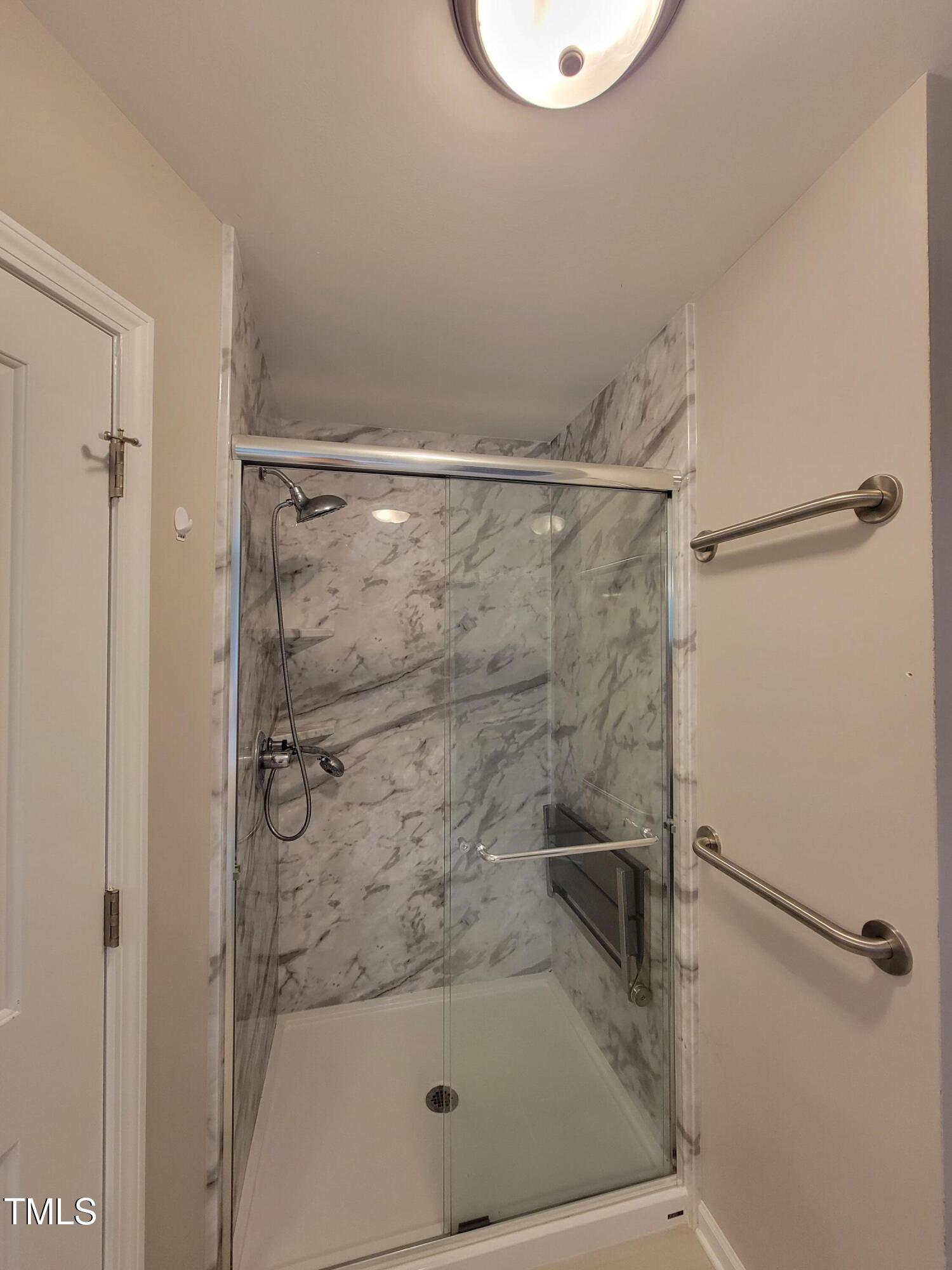 72 Mountain View Drive Garner, NC 27529 - Photo 20 of 22 a bathroom with a glass shower door