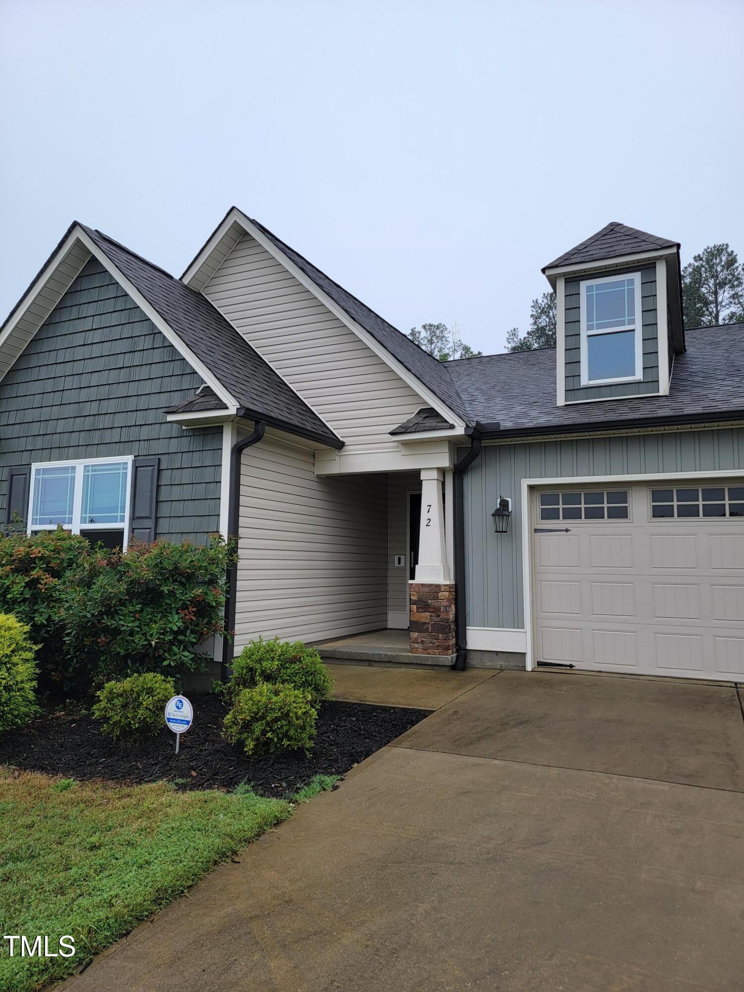 72 Mountain View Drive Garner, NC 27529 - Photo 3 of 22 a front view of a house with a yard and garage