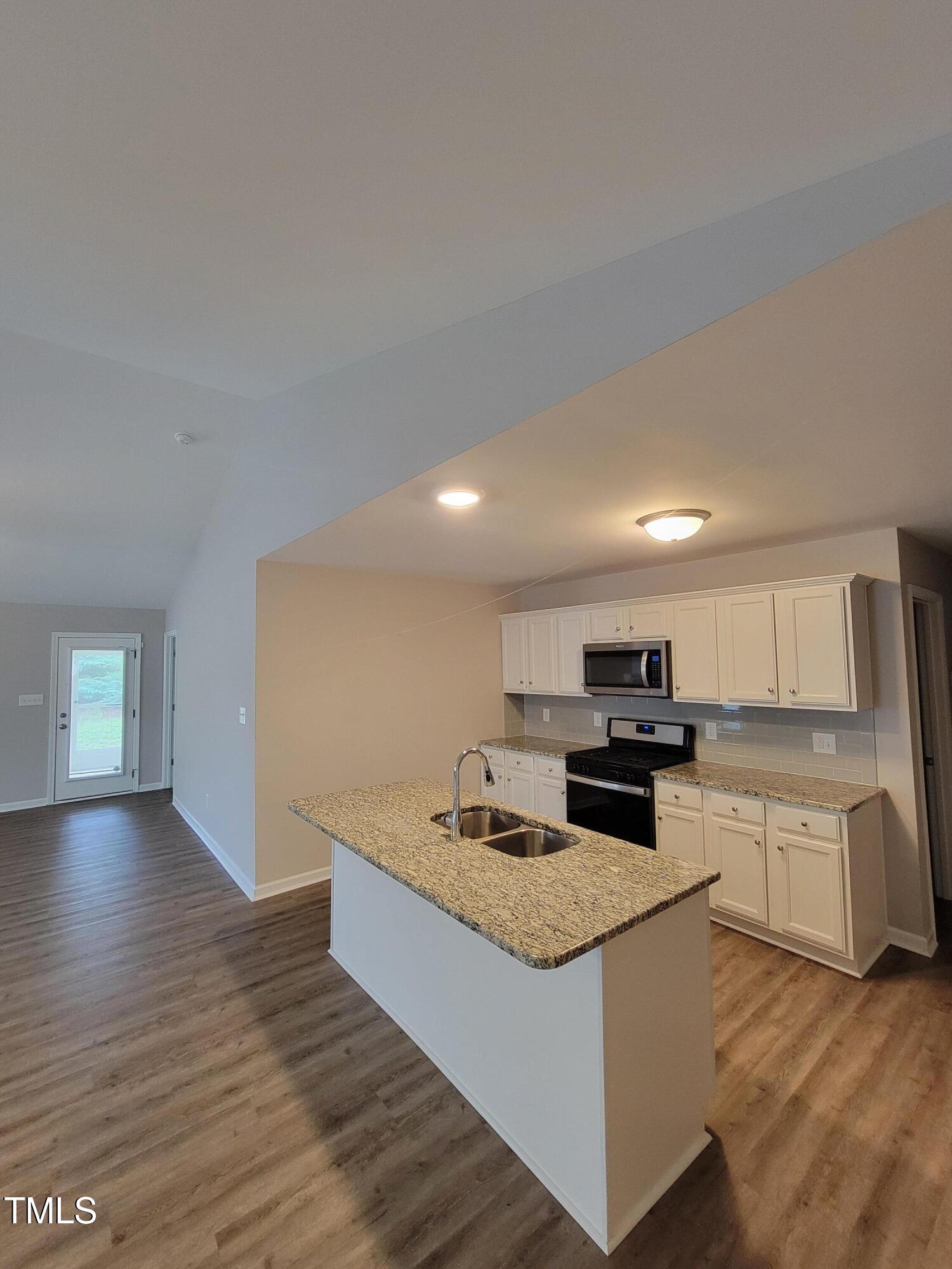 72 Mountain View Drive Garner, NC 27529 - Photo 6 of 22 a kitchen with stainless steel appliances granite countertop a sink stove and cabinets