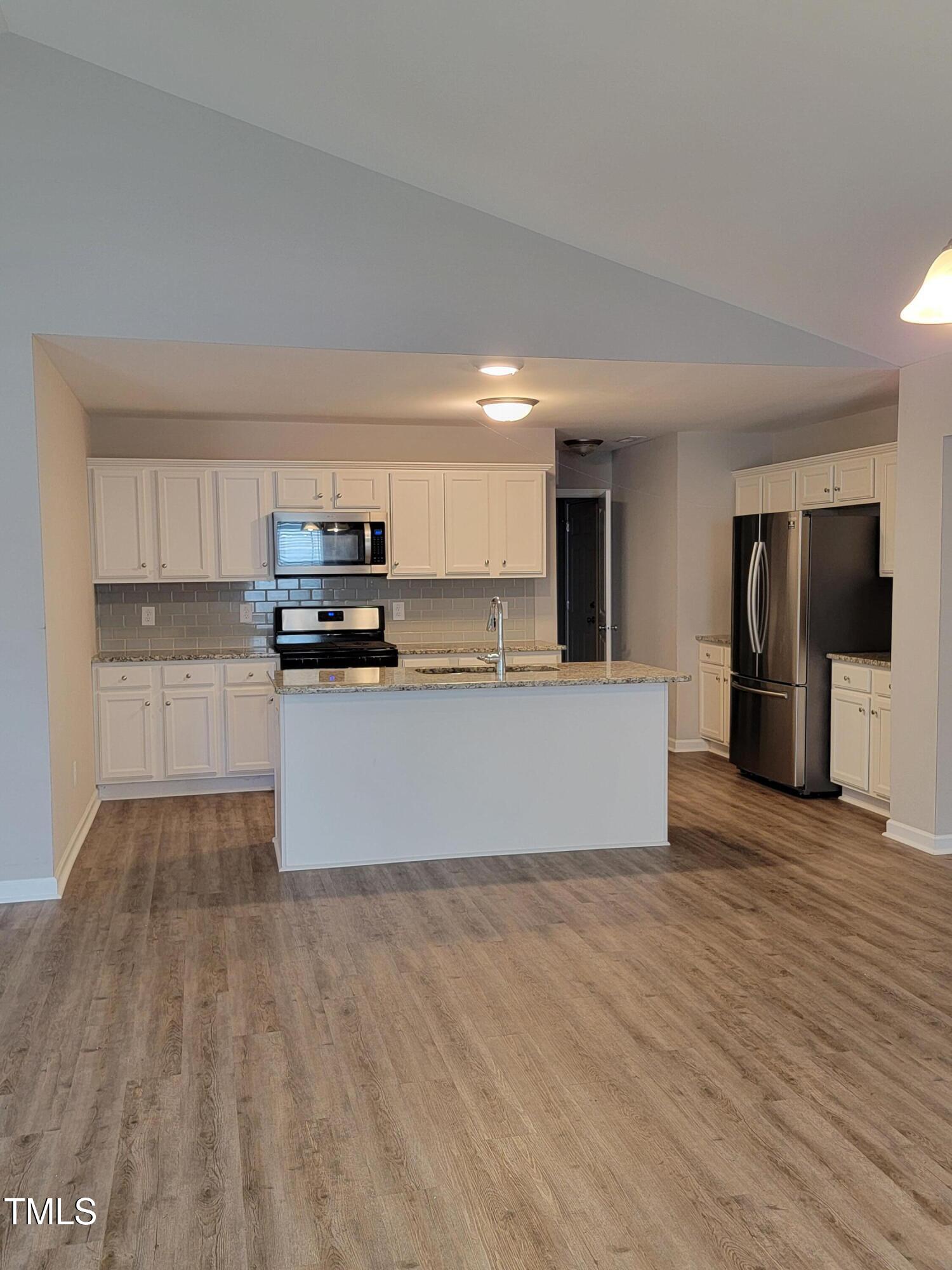 72 Mountain View Drive Garner, NC 27529 - Photo 8 of 22 a large kitchen with cabinets and stainless steel appliances